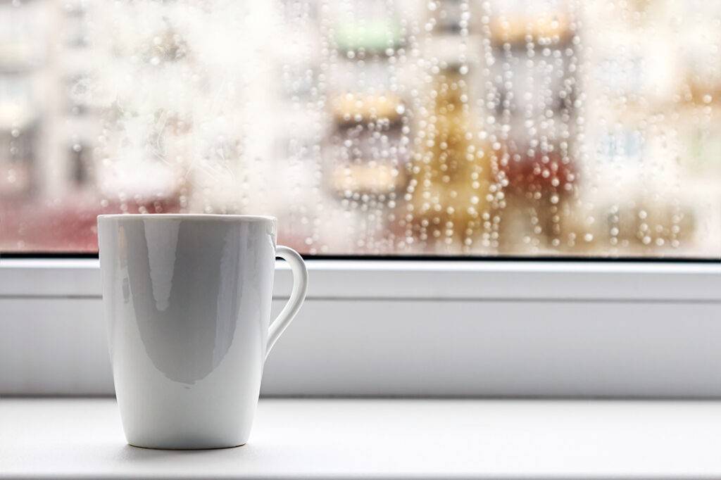 cup of hot coffee on the window